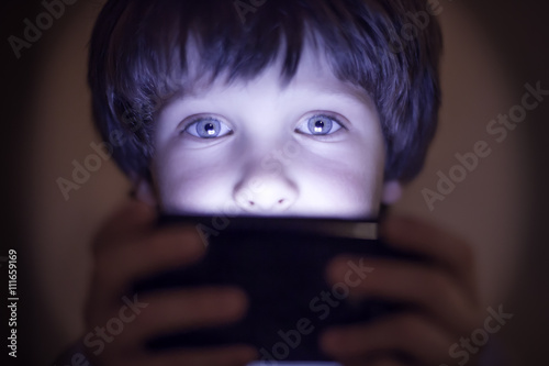 Small child playing on a smartphone