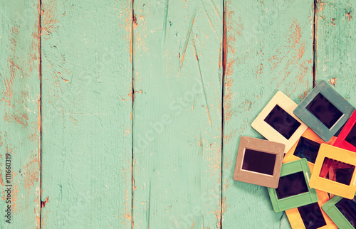 top view of old slides frames over wooden background