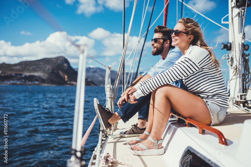  Young couple sitting on yacht in sea photo