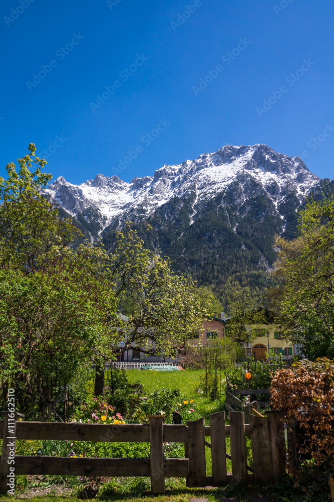 Das Gebirgsmassiv des Karwendel über einem idyllischen Garten in Mittenwald
