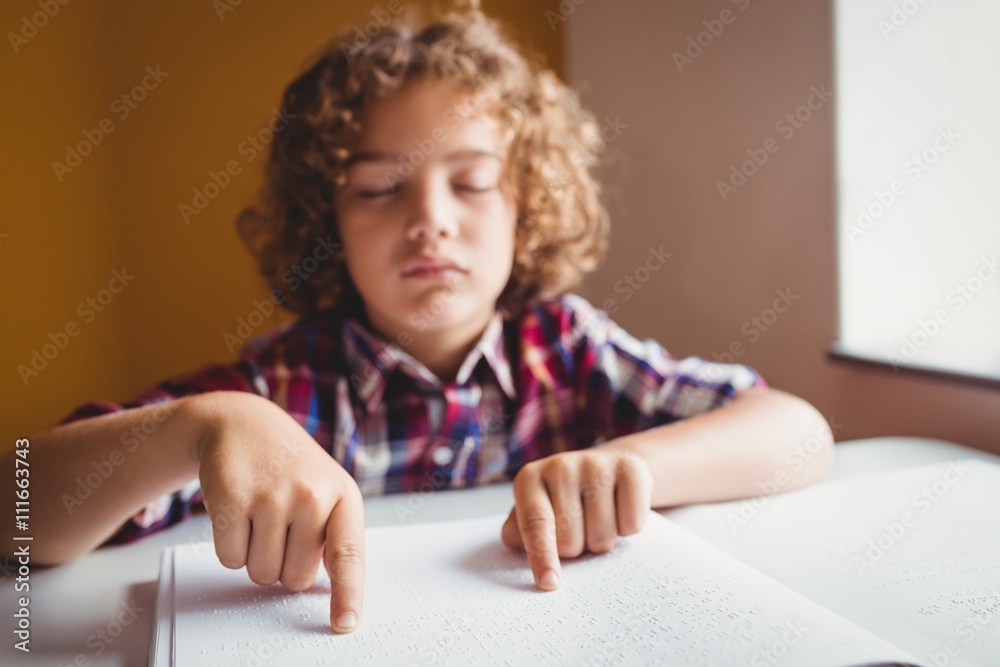 Boy using braille to read Boy using braille to read