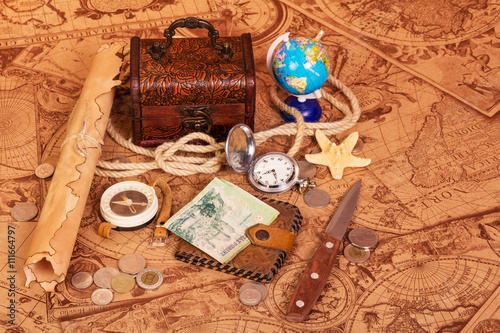 Accessories for the traveler on  background of antique maps.