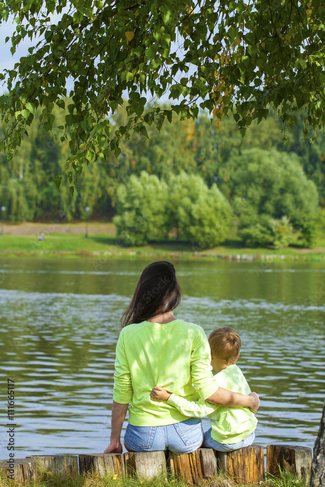 Young Mother and son playing in summer park Young Mother and son playing in summer park