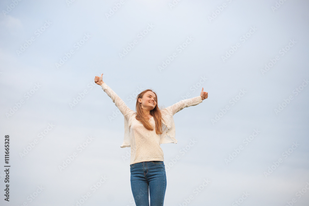 woman with open arms in the sky background at the morning woman with open arms in the sky background at the morning