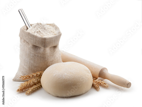 Dough, flour and rolling pin isolated on white background