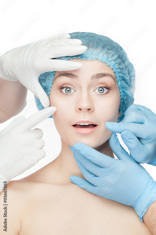 Plastic surgery concept. Doctor hands in gloves touching woman face Plastic surgery concept. Doctor hands in gloves touching woman face