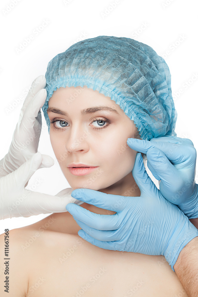 Plastic surgery concept. Doctor hands in gloves touching woman face Plastic surgery concept. Doctor hands in gloves touching woman face