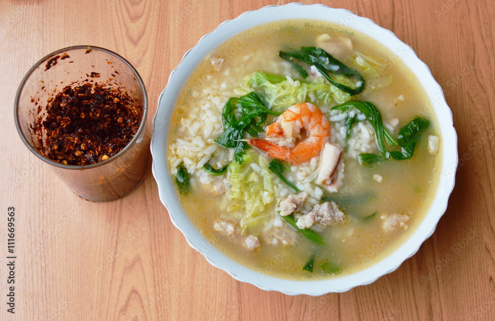 rice porridge with seafood and fried chili pasted in the glass rice porridge with seafood and fried chili pasted in the glass