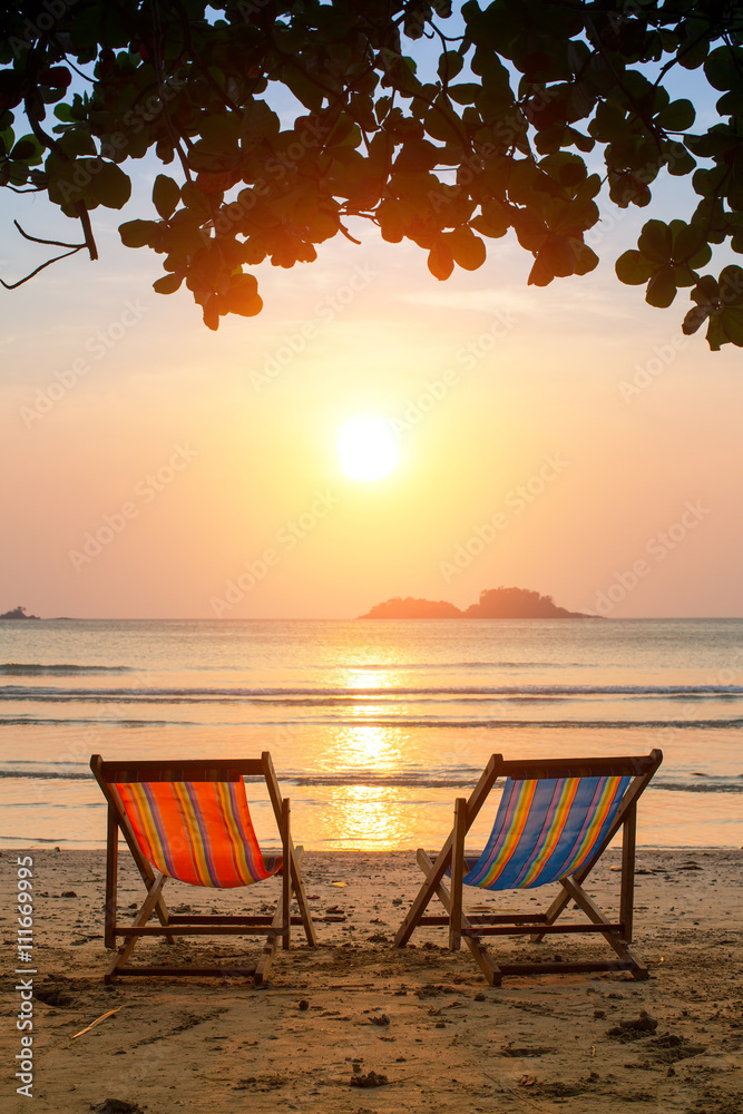 Loungers on the Sea beach at amazing sunrise.