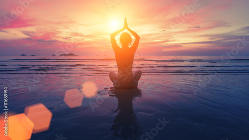 Woman yoga silhouette on the beach at amazing sunset. photo