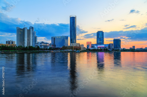 orange sunset over the city pond and the business part of the city of Yekaterinburg © vladimircaribb