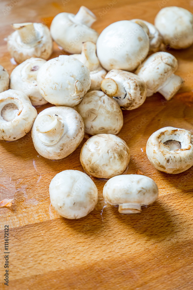 Whole Fresh White Mushrooms on Wooden Board. Whole Fresh White Mushrooms on Wooden Board.