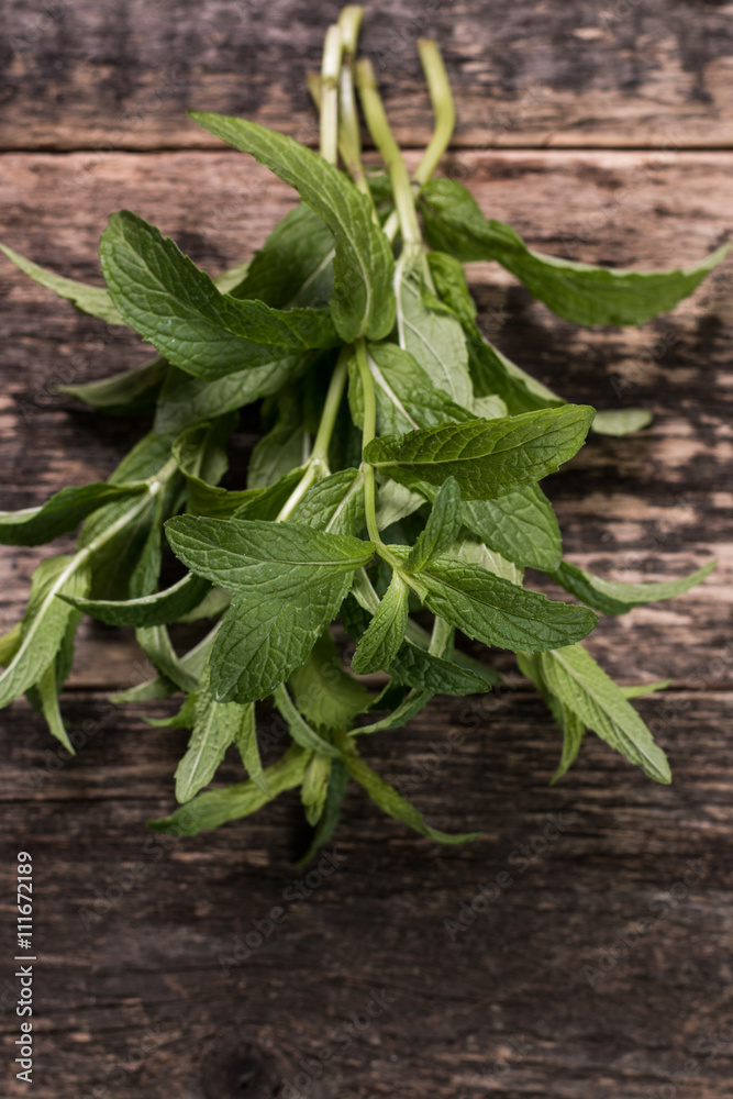 Green fresh mint on the wooden table, selective focus