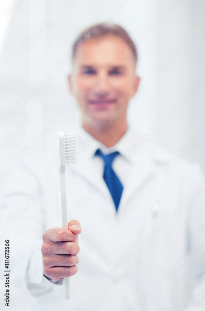 dentist with toothbrush in hospital