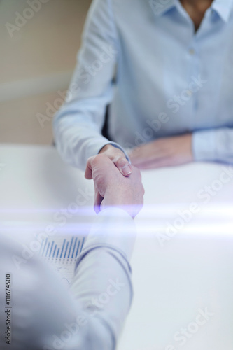 businesswoman and businessman shaking hands
