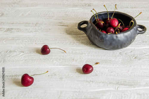 Cherries in a ceramic bowl. Copyspace.