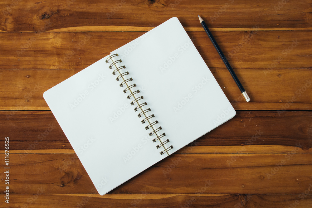 Blank notepad with pencil on office wooden table Blank notepad with pencil on office wooden table