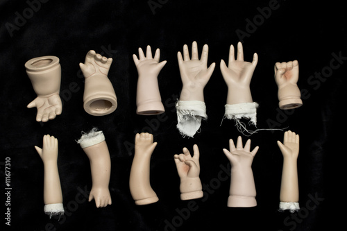 Obraz na plátně Broken Doll Body Parts on Black Background