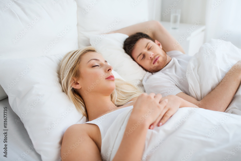 happy couple sleeping in bed at home happy couple sleeping in bed at home
