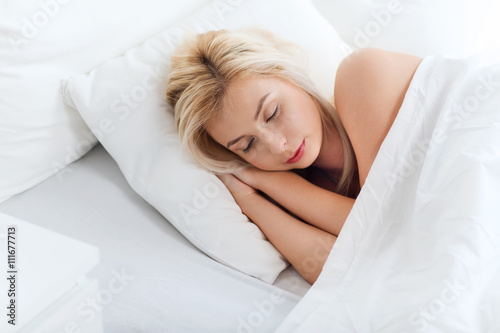 young woman sleeping in bed at home bedroom
