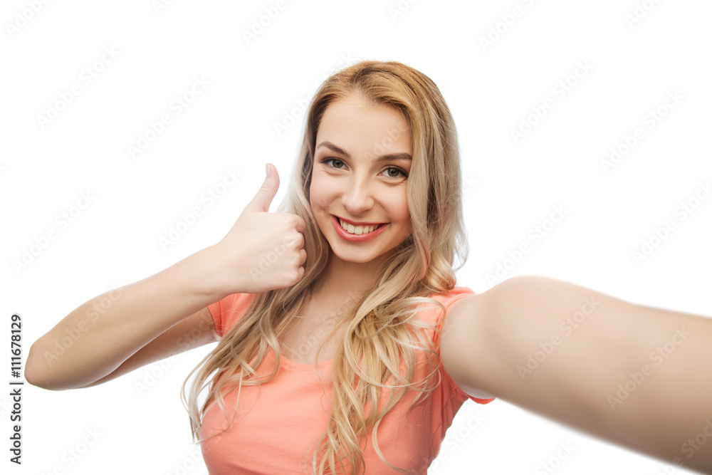 happy woman taking selfie and showing thumbs up happy woman taking selfie and showing thumbs up
