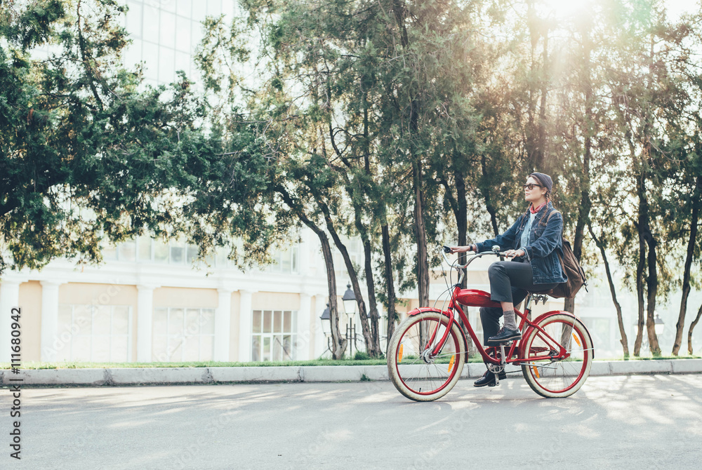 female riding vintage bicycle in park 