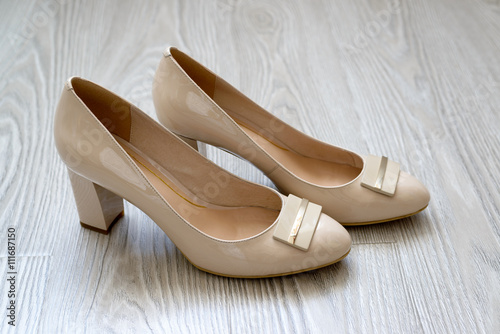 Beautiful beige women shoes on the floor