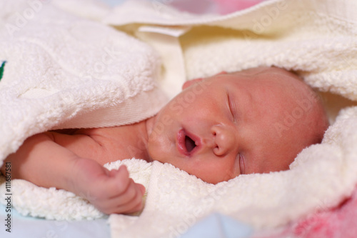 Newly bathed newborn baby sleeps