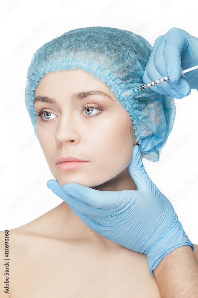 Attractive woman at plastic surgery with syringe in her face