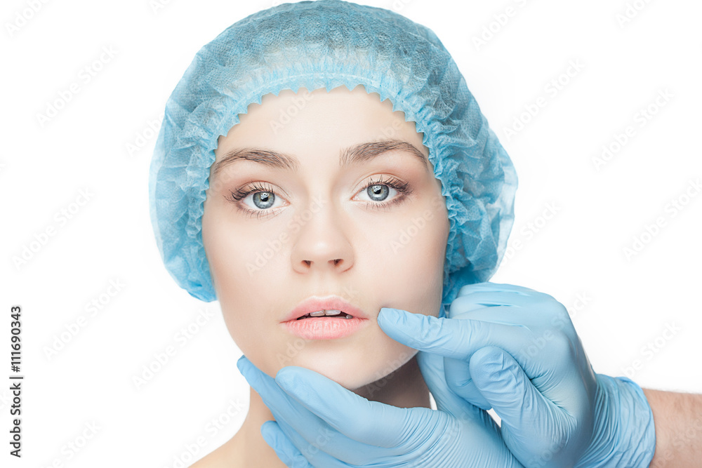Plastic surgery concept. Doctor hands in gloves touching woman face Plastic surgery concept. Doctor hands in gloves touching woman face