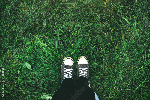 фотографія Young man standing in freshly mown grass lawn