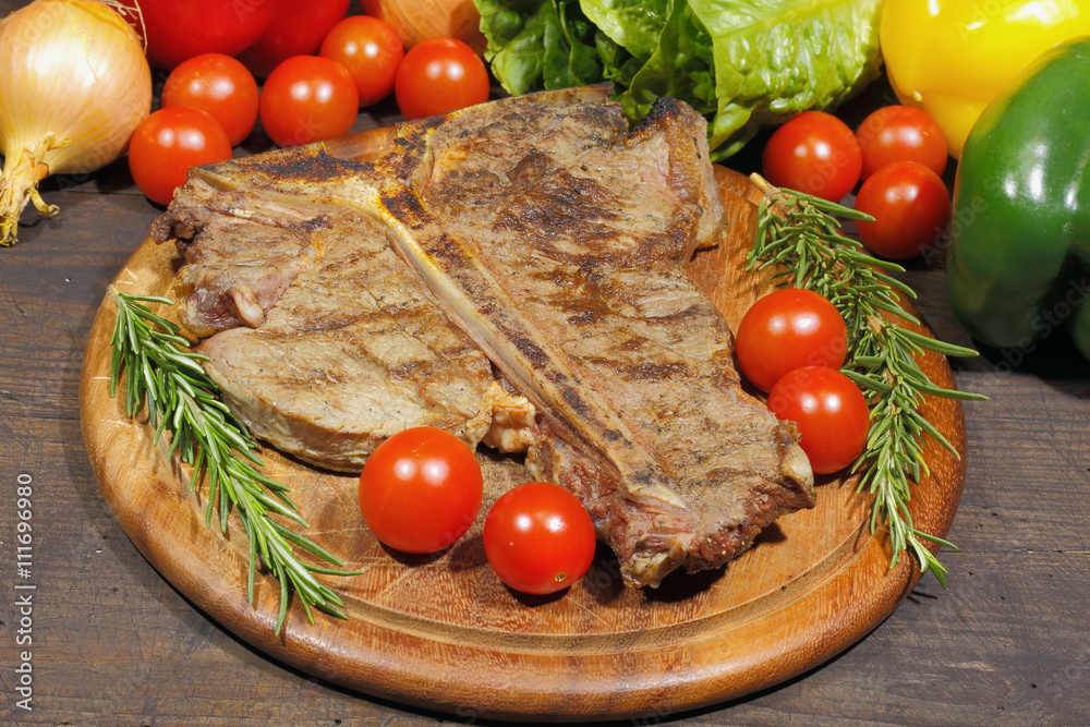 Grilled T bone steak with rosemary tomatoes, paprika onions and Grilled T bone steak with rosemary tomatoes, paprika onions and