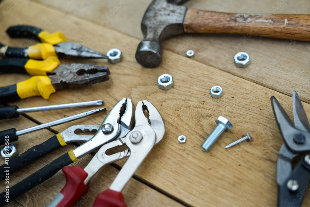 Closeup flat lay of tools on a wooden surface Closeup flat lay of tools on a wooden surface