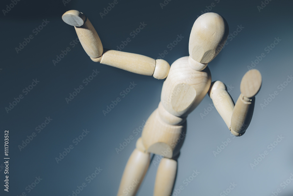 Wooden mannequin dummy on a blue background Wooden mannequin dummy on a blue background