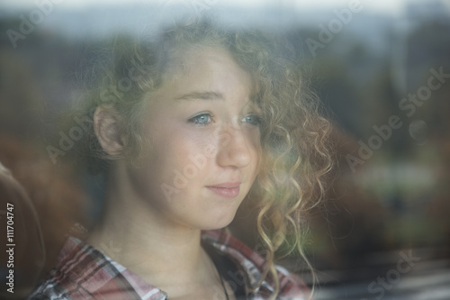 Portrait of Beautiful Redhead Girl Behind Glass with reflection