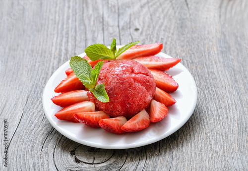 Fruit strawberry sorbet with mint in a white plate