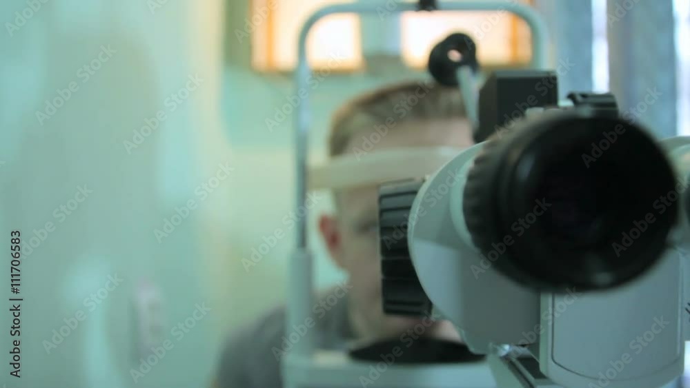 Doctor optometrist ophthalmologist examines the retina to the patient with the help of a special device 2 Doctor optometrist ophthalmologist examines the retina to the patient with the help of a special device 2