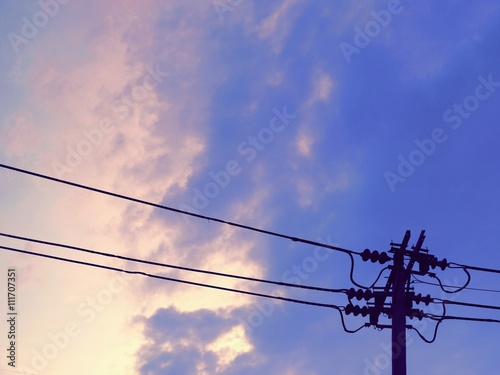 Electric post  against blue sky