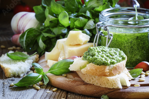 Bruschetta with fresh pesto sauce, hard cheese, nuts, basil, vin