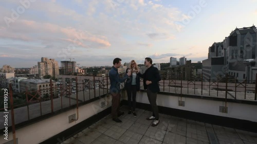 Wallpaper Mural Young people talking and drinking champagne on the roof of an office building at summer evening - sunset over the city Torontodigital.ca