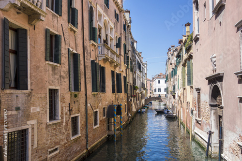 Boats on small canal in Venice, Italy.