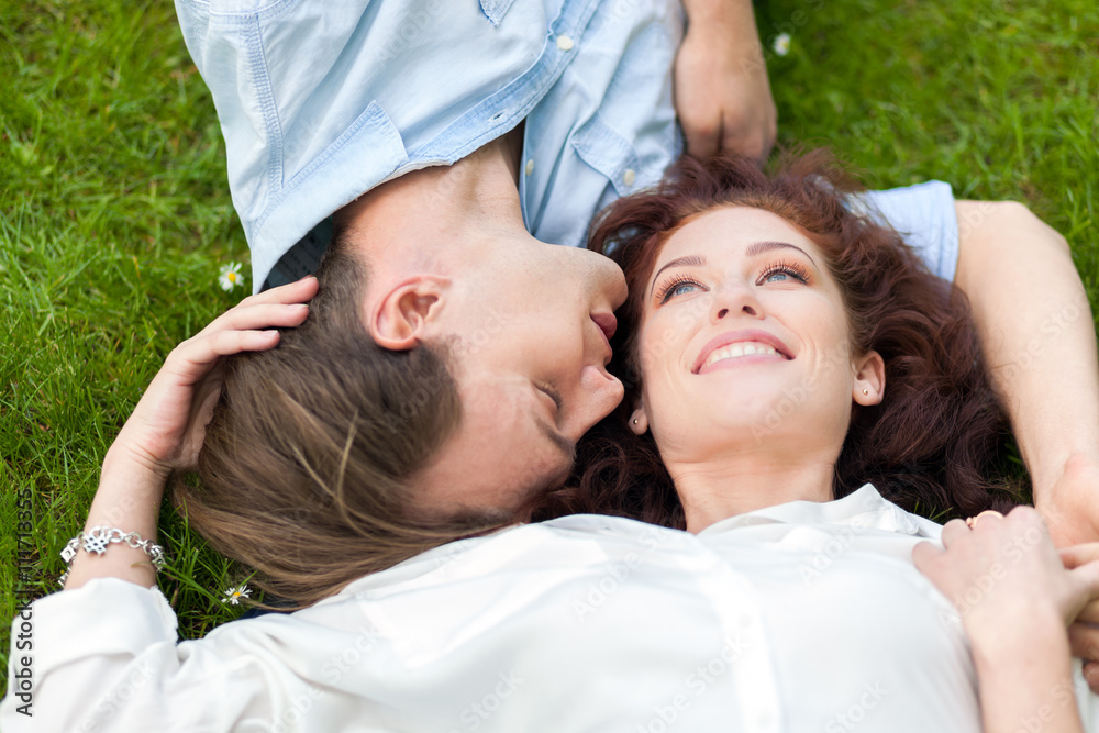 Loving couple lying on the grass Loving couple lying on the grass