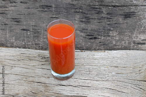 Tomato juice on wooden background