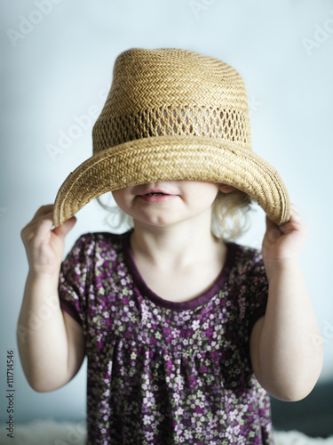 Portrait of a girl wearing a hat too big, Sweden. photo
