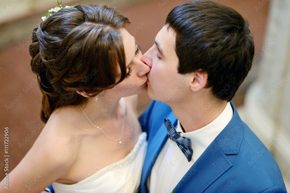 Wedding couple indoors is hugging each other. Beautiful model girl in white dress. Man in suit. Beauty bride with groom. Female and male portrait. Woman with lace veil. Cute lady and handsome guy Wedding couple indoors is hugging each other. Beautiful model girl in white dress. Man in suit. Beauty bride with groom. Female and male portrait. Woman with lace veil. Cute lady and handsome guy