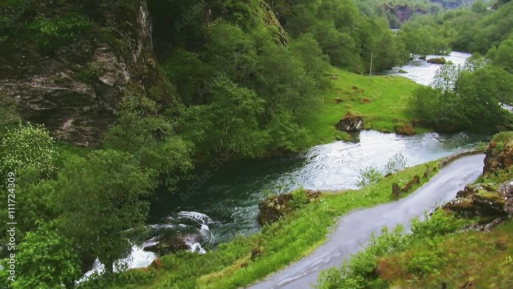 Train drive on road in mountains. Hills. Lot of greenery. River flows between mountains. Summer day. Landscape. Nature. Camera inside train Train drive on road in mountains. Hills. Lot of greenery. River flows between mountains. Summer day. Landscape. Nature. Camera inside train