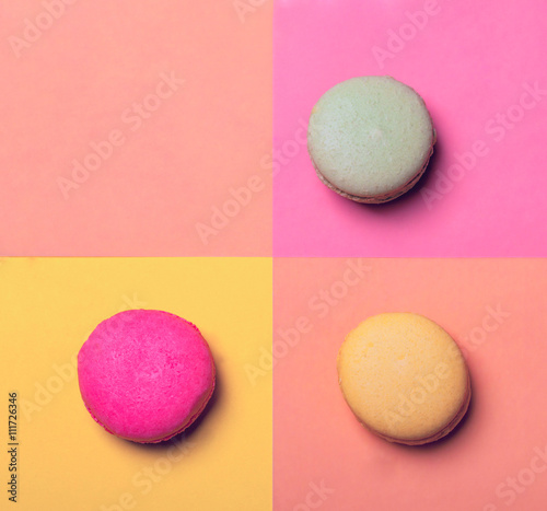 Three macarons on colorful background