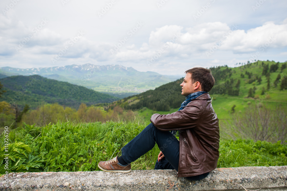 Male hiker relaxing on top of a mountain Male hiker relaxing on top of a mountain
