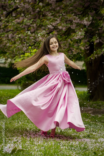 Little girl in pink dress with blossom