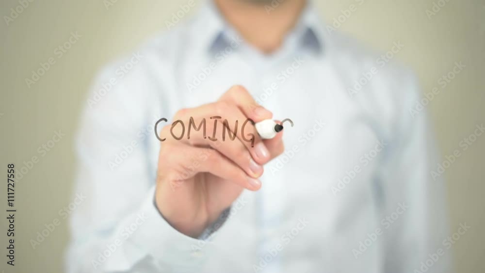 Coming Soon, Man writing on transparent screen Coming Soon, Man writing on transparent screen